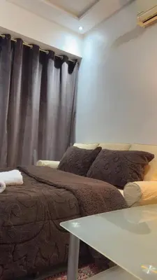 a room with a bed and a table and a curtain at شقة الفن Art Apartment in Marrakech