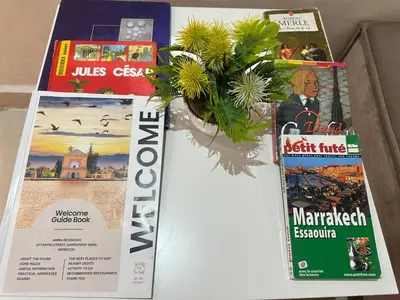 two magazines and a vase with flowers on a table at Chic & Lovely Flat in City Center in Marrakech