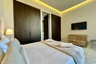 a bedroom with a large white bed and a tv at Luxury living/Terrace/Pool in Marrakech