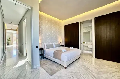 a bedroom with a large bed and a bathroom at Luxury living/Terrace/Pool in Marrakech
