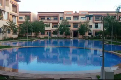 a large swimming pool in front of a building at Appartement Marrakech luxe in Marrakech
