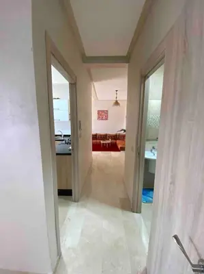 a hallway of a house with a room with a kitchen at Appartement Marrakech luxe in Marrakech