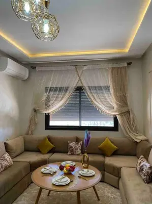a living room with a couch and a table at Appartement Marrakech luxe in Marrakech