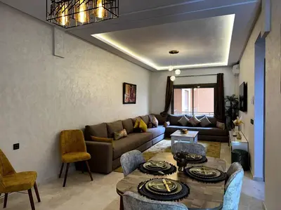 a living room with a couch and a table at App centre-ville in Marrakech