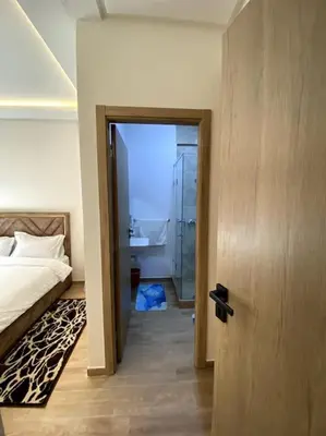 a bedroom with a bed and a walk in shower at App centre-ville in Marrakech