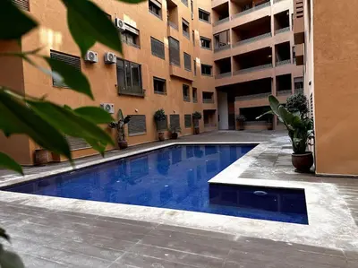 a swimming pool in the courtyard of a building at App centre-ville in Marrakech