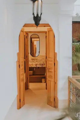 an open door into a bathroom with a mirror at Riad Babel au coeur de la Médina in Marrakech