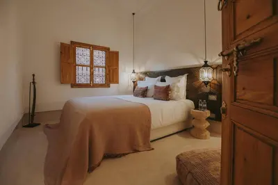 a bedroom with a large white bed with pillows at Riad Babel au coeur de la Médina in Marrakech