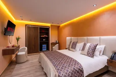 a hotel room with a bed and a television at Swiss Continental Hôtel in Marrakech