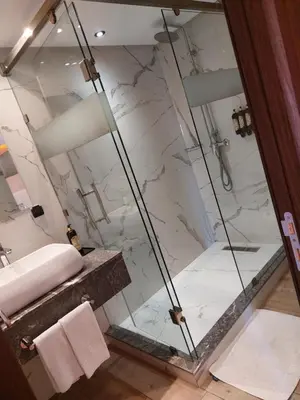 a bathroom with a shower and a sink at Swiss Continental Hôtel in Marrakech