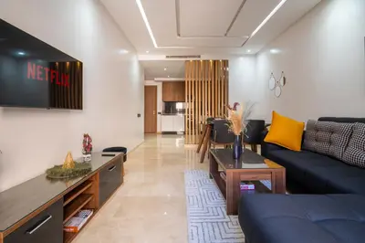 a living room with a couch and a tv at Royal KING Bed SUITE W/POOL in Marrakech