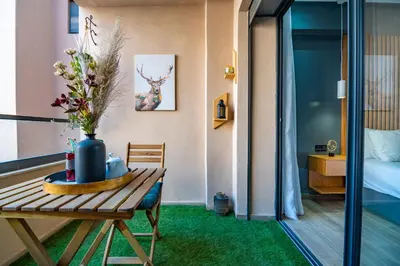 a room with a table with a vase of flowers on it at Royal KING Bed SUITE W/POOL in Marrakech