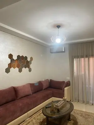a living room with a couch and a table at Luxury apart à Gueliz Marrakech in Marrakech