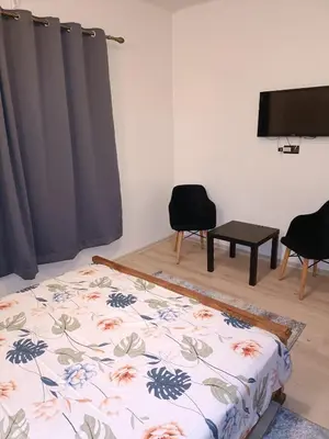 a bedroom with a bed and a flat screen tv at 1 Room only for women للنساء فقط in Marrakech