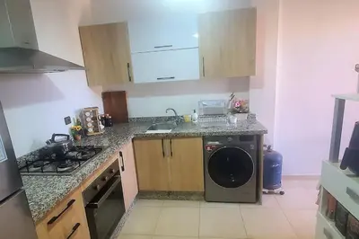 a kitchen with a sink and a washing machine at appartement chic haut standing centre gare in Marrakech