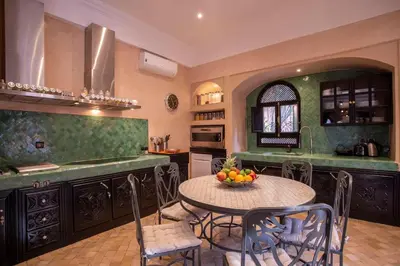 a kitchen with a table with a bowl of fruit on it at Dar Ines - Palmeraie, 250m2, pool, patio, terrace in Marrakech