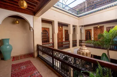 an indoor hallway of a house with a balcony at Riad Amalia in Marrakech