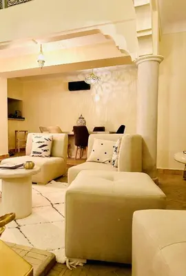 a living room with two couches and a table at Riad le R - Riad privatif de luxe in Marrakech