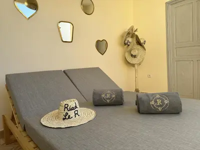 a bedroom with a bed with a hat and a fan at Riad le R - Riad privatif de luxe in Marrakech