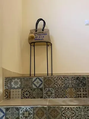 a basket sitting on top of a shelf with tiles at Medina House in Marrakech