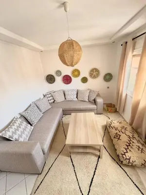a living room with a couch and a coffee table at Musée YSL Cozy, Familial, Chic in Marrakech