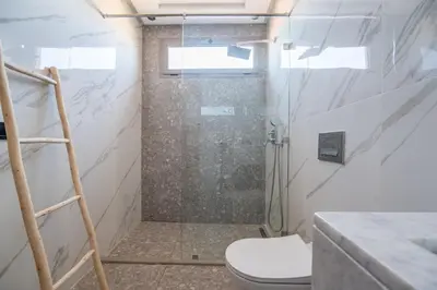 a bathroom with a shower and a toilet at Villa Saadia in Douar Bellouk