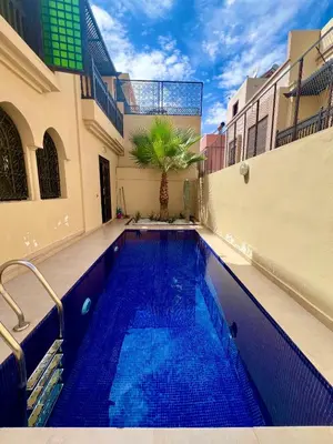 a swimming pool in the middle of a building at Villa Al Nour avec piscine in Marrakech