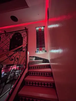 a staircase with red lights in a room at Riad le pélican in Marrakech