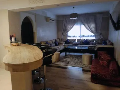 a living room with a couch and a table at APPARTEMENT DOUILLET AU CENTRE GUELIZ in Marrakech