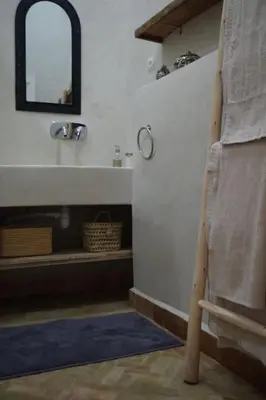 a bathroom with a sink and a mirror and a towel at Riad Les Jardins de Kenza, idéalement situé, 5 minutes de la place Jemaa El Fna in Marrakech