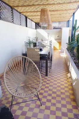 a dining room with a table and a chair at Riad Les Jardins de Kenza, idéalement situé, 5 minutes de la place Jemaa El Fna in Marrakech