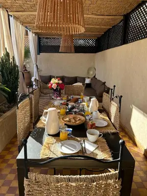 a dining room table with food on it at Riad Les Jardins de Kenza, idéalement situé, 5 minutes de la place Jemaa El Fna in Marrakech