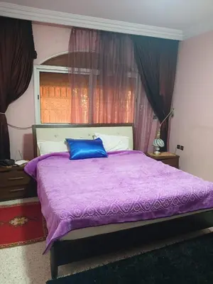 a bedroom with a purple bed with a blue pillow at Villa Mima in Marrakech