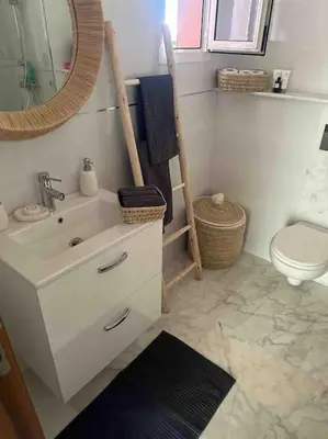 a bathroom with a sink and a toilet and a mirror at Appartement Luxe Riad Garden Marrakech 3 piscines in Marrakech