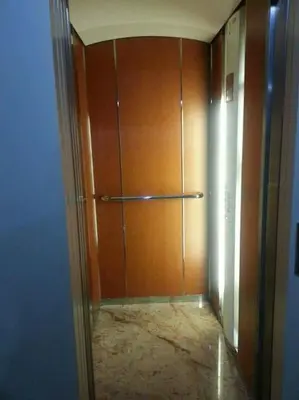 a hallway with a wooden door in a room at Appartement de prestige au quartier de l’Hivernage, Marrakech in Marrakech