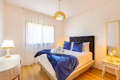 a bedroom with a large bed with blue pillows at Prestigia Saphir,Piscine, Jardin in Marrakech