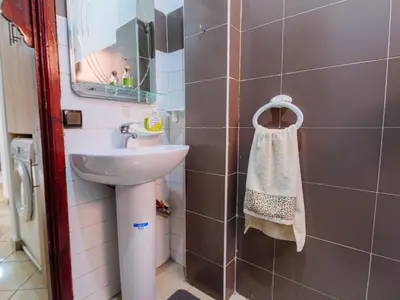 a bathroom with a sink and a mirror at Family Illuminated Apartment With Pool in Marrakech
