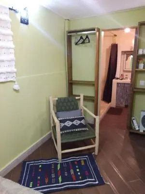 a room with a chair and a rug at Riad Bouganville Bleu in Marrakech