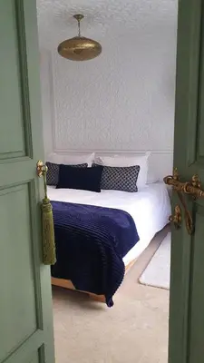 a bedroom with a bed with blue and white pillows at Riad Fisaline en exclusivité pour vous à Marrakech in Marrakech