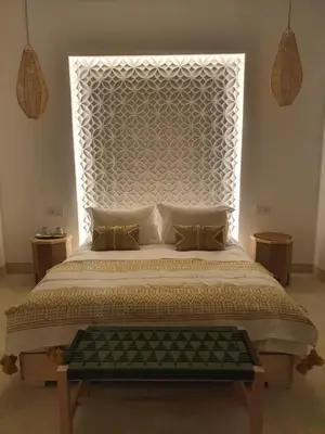 a bedroom with a large bed with a large headboard at Riad Fisaline en exclusivité pour vous à Marrakech in Marrakech