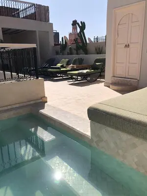 a swimming pool with some lounge chairs in a patio at Riad Fisaline en exclusivité pour vous à Marrakech in Marrakech