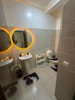 a bathroom with a sink and a toilet and a mirror at Marrakech airport apartment in Marrakech