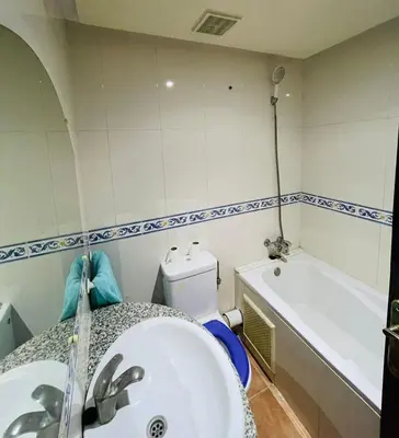 a bathroom with a sink and a tub and a toilet at Big Gardens 3 in Marrakech
