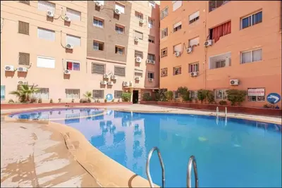 a swimming pool in front of two apartment buildings at Big Gardens 3 in Marrakech