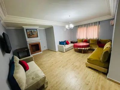 a large living room with couches and a fireplace at Big Gardens 3 in Marrakech