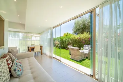 an open living room with sliding glass doors at Central & comfy 3BR apartment with pool & wifi access in Marrakech
