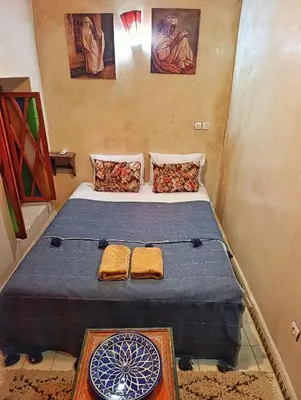 a bedroom with a bed with a dartboard on it at Medina house in Marrakech