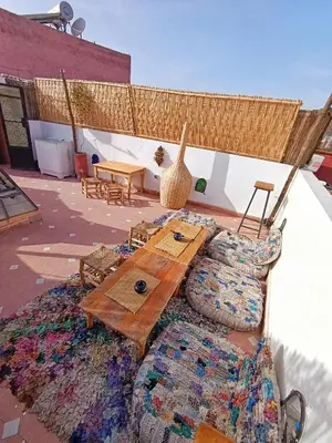 a wooden table and a couch sitting on a patio at Medina house in Marrakech