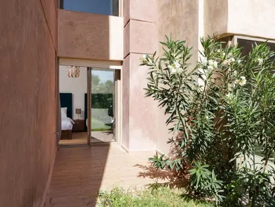 an internal courtyard of a house with plants at Apart Confort Front Pool-Garden in Marrakech