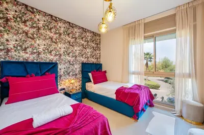 a bedroom with two beds and a window at Exceptional Style Nonstop Luxury in Marrakech